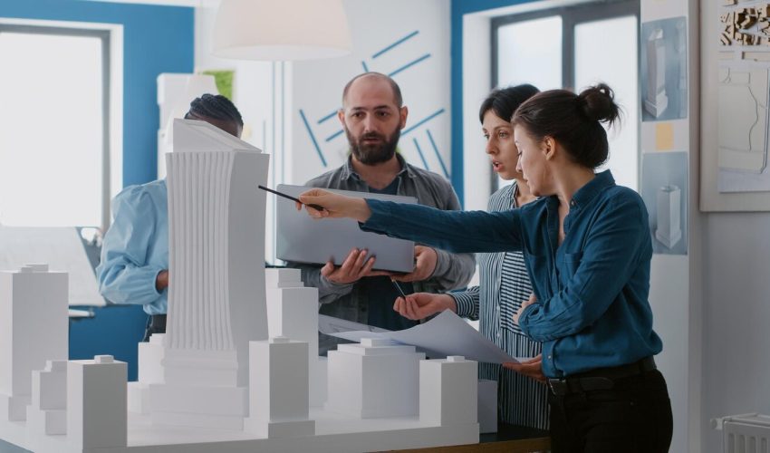 multi-ethnic-people-working-with-laptop-tablet-building-model-architecture-project-coworkers-doing-teamwork-design-maquette-construction-layout-with-blueprints_482257-38871 multi-ethnic-people-working-with-laptop-tablet-building-model-architecture-project-coworkers-doing-teamwork-design-maquette-construction-layout-with-blueprints_482257-38871
